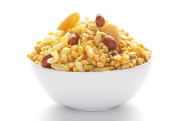 Close up of Bhel puri Indian namkeen (snacks) on a ceramic white bowl.