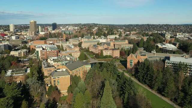Cinematic aerial dolly drone footage of the University of Washington with the surrounding lecture halls, dormitories and classroom buildings in the background