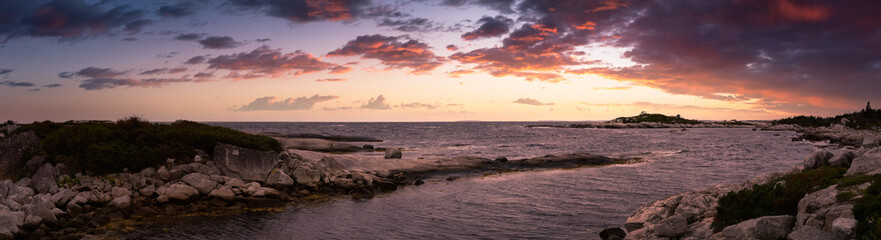 Scenic View of a rocky coast on the Atlantic Ocean during a cloudy morning. Colorful Sunrise Sky Art Render. Located in Peggys Cove, near Halifax, Nova Scotia, Canada