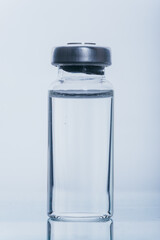 Glass medical ampoule vial for injection. Medicine is dry white drug penicillin powder or liquid with of aqueous solution in ampulla. Close up.