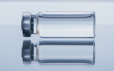 Glass medical ampoule vial for injection. Medicine is dry white drug penicillin powder or liquid with of aqueous solution in ampulla. Close up.