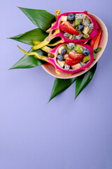 Tropical dragon fruit on colourful background. Minimalism design concept.