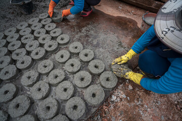 Female construction worker making concrete material in construction site