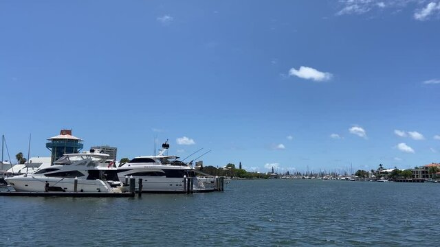 A peaceful marina with sleek white cruiser baots, under perfect blue summer skies