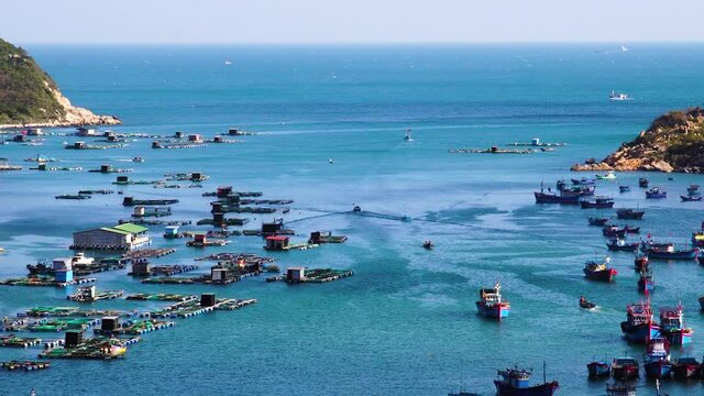Panorama of Vinh Hy Bay, Vietnam crowed by anchored ships and fish farms