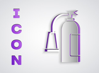 Paper cut Fire extinguisher icon isolated on grey background. Paper art style. Vector