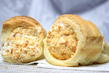 Puff pastry tubes with protein cream close-up.