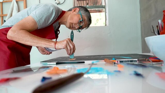 Artist working with paint for a monotype print