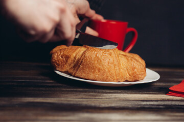 two croissants on a plate a cup of coffee wooden table dessert meal