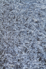 ice pattern consisting of frozen ice needles on a dark background