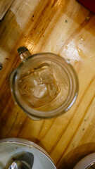 empty glass where there is still a chunk of ice after eating