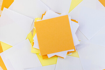 A stack of empty multicolored note sheets among the scattered paper.