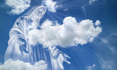 Close up of Mary in white clouds with light ray from heaven. religion,