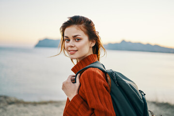 happy woman travel tourism backpack ocean mountains sea