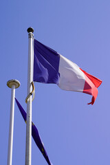 French flag waving in mat front of city hall in town of france