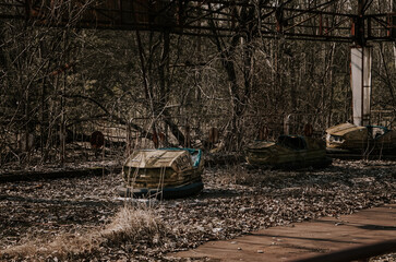 Broken metal radioactive cars in amusement park in the city of Pripyat, the Chernobyl disaster