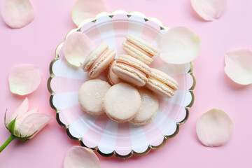 Light Pink Macarons on the twisted white and pink plate on pink background 