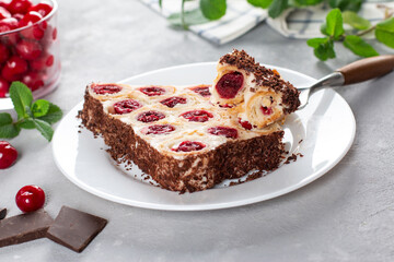 Monastic hut pie. Homemade cakes, sweet cake with cherry filling and cream. Collected from tubes, dough is rolled. Festive food for dessert
