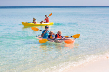 Kids kayaking in ocean. Family in kayak in tropical sea