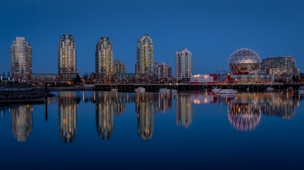 Naklejka premium Vancouver Skyline at the Blue Hour with Lights on the Science Center Globe at night on the Eastern Shore of False Creek Inlet, British Columbia, Canada