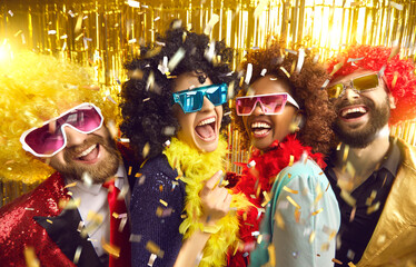Happy crazy friends diverse group with different ethnicity wearing funny wigs, glittering jacket, boa scarf, eyeglasses celebrating birthday headshot portrait. Time for fun, corporate costumed party
