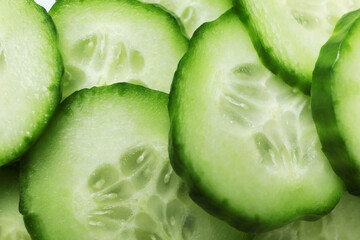 Ripe cucumber slices on whole background, close up