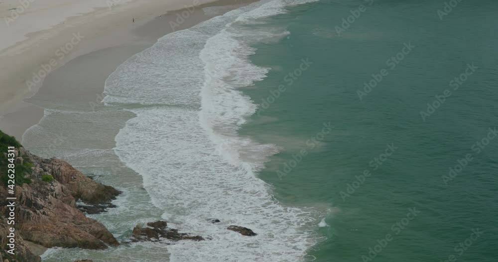 Poster Sea wave over the rocky beach