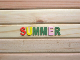 Word Summer on wood background