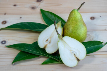 Top view Fresh Pear with slices closeup, Green Pear on wooden table in garden.