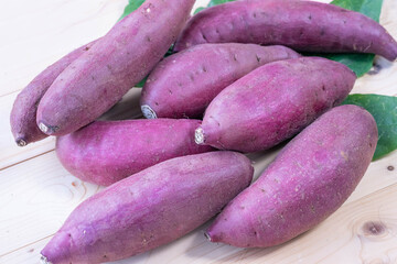 Top view Fresh sweet potato closeup, Japanese Sweet Potato on wooden table in garden.