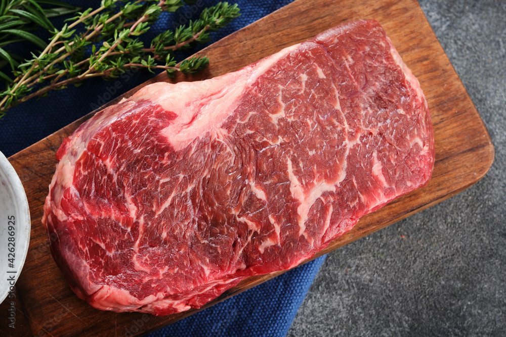 Wall mural fresh raw new-york steak top view.