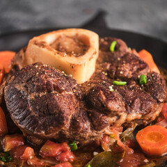 Beef Leg Slice with marrow. Italian menu: braised veal steak Ossobuco alla Milanese with  vegetable sauce. Selective fosus.
