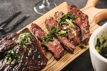 Poster Hanger steak bbq with souce chimichurri, close up © FoodAndPhoto