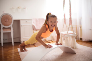 Little girl working crunches.