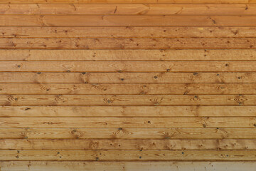 Naklejka premium wall of brown wooden planks arranged horizontally