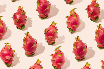 .Authentic pattern made of exotic delicious dragon fruit. Gentle pink color background. .