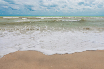 Fototapeta na wymiar Beach with waves and bright blue sky