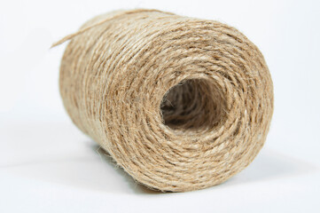 a skein of jute rope on a white background with a large plan