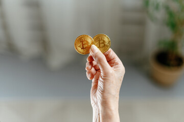 image of two bitcoins in the hands of a woman.