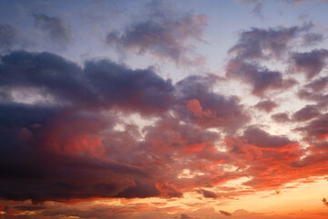 Calm sea with sunset sky and sun through the clouds over.