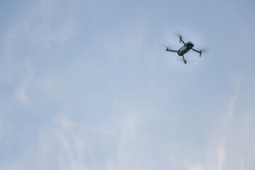 Fototapeta na wymiar drone in the sky, grey color drone, blue sky in background