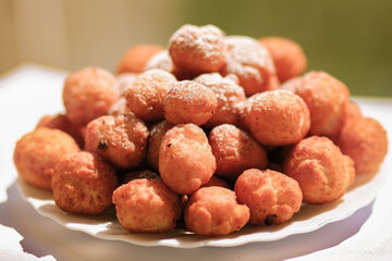 donut balls with powdered sugar eat outdoors