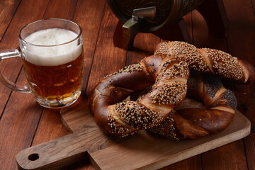 Bagels with sesame and poppy seeds and a mug of beer.