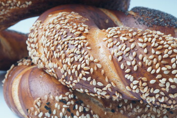 Fresh bread bagel with poppy and  sesame coating. Jewish or  German  form of sweet-filled pastry