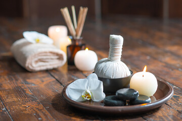 Obraz na płótnie Canvas Spa background. Towel, candles, flowers, aroma sticks, massaging stones and herbal balls. Massage, oriental therapy, wellbeing and meditation.