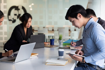 Group of Businessman and Accountant checking data document on digital tablet for investigation of...