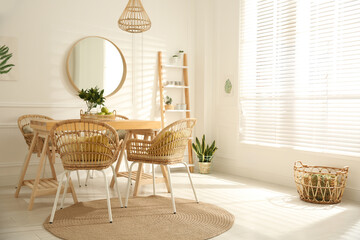 Stylish wooden dining table and chairs in room. Interior design