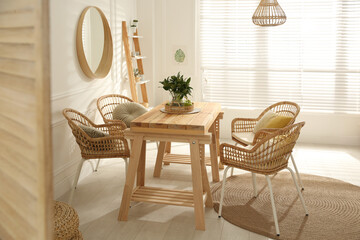 Stylish wooden dining table and chairs in room. Interior design