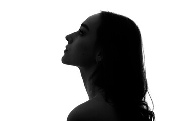 The silhouette of a young woman's head in profile on a white background. - 426304918
