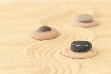 Fototapeta na wymiar Stones on the sand - summer background for relaxation